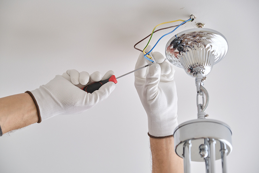 electrician-hands-installing-new-ceiling-lamp-at-residential-property-interiors-acworth-ga